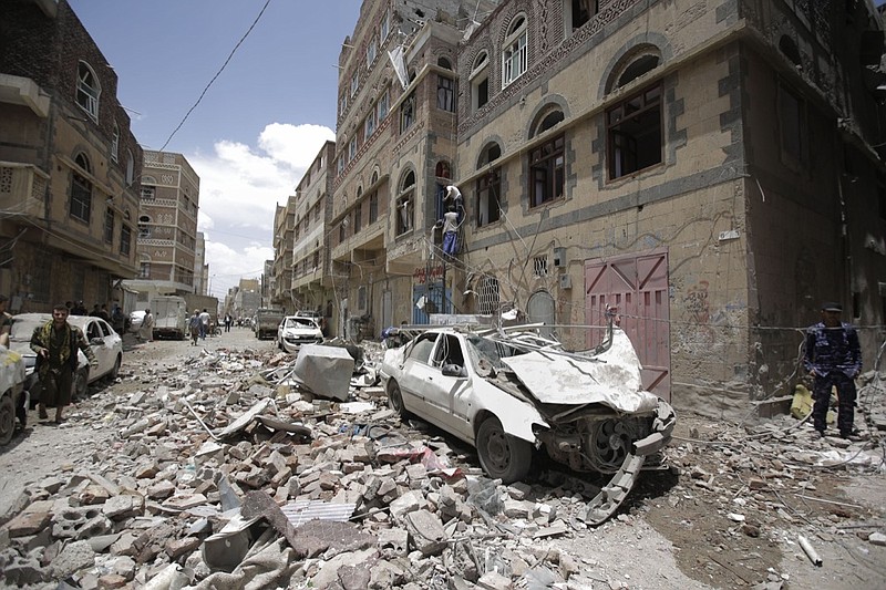 People inspect the site of an airstrike by Saudi-led coalition in Sanaa, Yemen, Thursday, May, 16, 2019. Yemen's human rights minister says heavy fighting is underway in the country's south as rebel Houthis push to gain more territory from government forces and their allies. The clashes come as the Saudi-led coalition carried out airstrikes on the capital, Sanaa, earlier on Thursday, targeting the Houthis and killing at least three civilians. (AP Photo/Hani Mohammed)