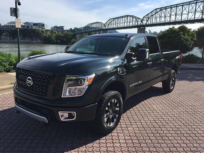 The 2019 Nissan Titan XD is shown in  Midnight Pine. 

