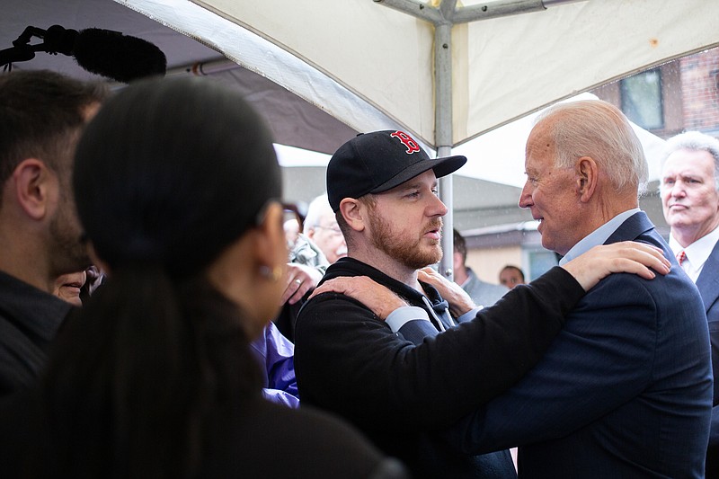 Former Vice President Joe Biden embraces an attendee at a campaign event in Nashua, New Hampshire last Tuesday. (Elizabeth Frantz/The New York Times) - XNYT245