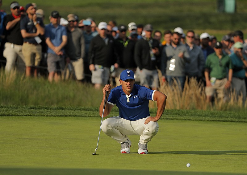 Brooks Koepka lines up a putt on the 17th green during the second round of the PGA Championship on Friday in Farmingdale, N.Y. Koepka shot a 65, set the scoring record for 36 holes at a major and led by seven strokes.