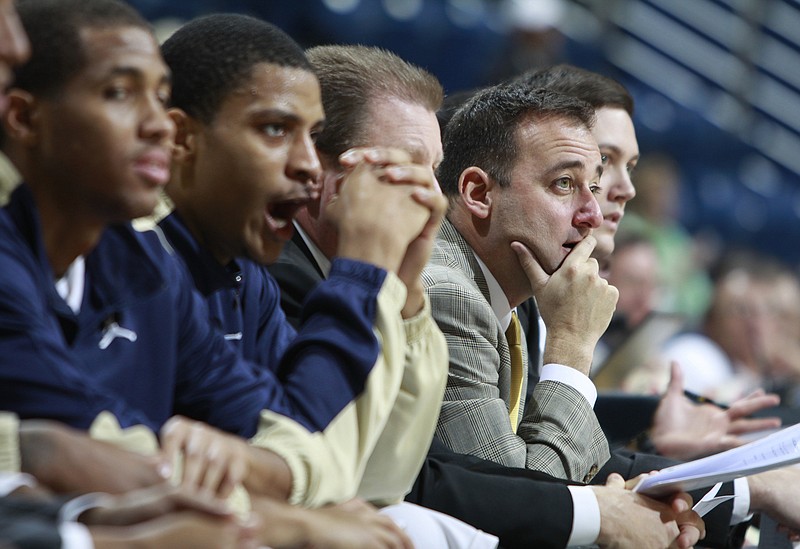 John Shulman rests his chin on his right hand as he watches the UTC men's basketball team take on Reinhardt in December 2010 at McKenzie Arena. Shulman was an assistant for the Mocs from 2002 to 2004 and their head coach from 2004 to 2013.