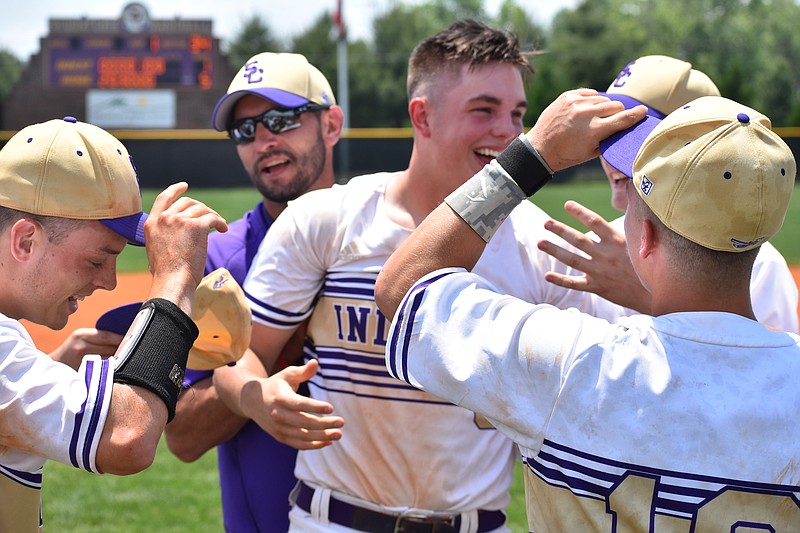 Sequatchie County senior pitcher Collin Hudson, center, is all smiles with his teammates and coaches after the Indians beat visiting Signal Mountain 5-1 Saturday to advance to the Class AA state tournament. Hudson improved to 11-0 and has a 1.70 ERA after his complete game against the Eagles.