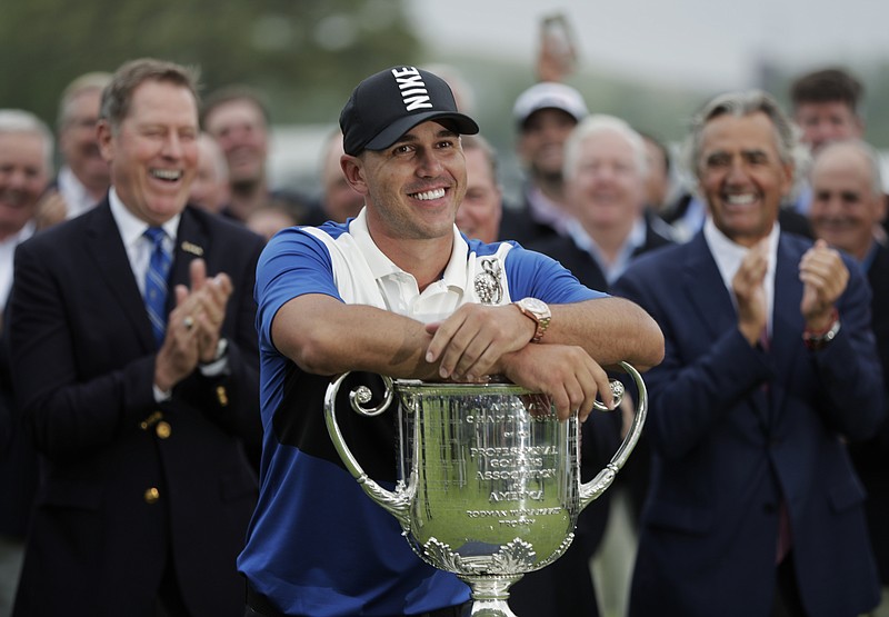 Brooks Koepka poses with the Wanamaker Trophy after winning the PGA Championship on Sunday at Bethpage Black in Farmingdale, N.Y.