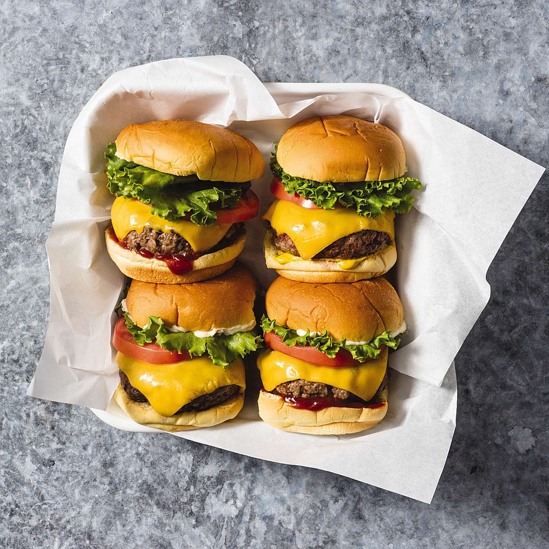 This undated photo provided by America's Test Kitchen in May 2019 shows Classic Beef Burgers in Brookline, Mass. This recipe appears in the cookbook "The Ultimate Burger." (Daniel J. van Ackere/America's Test Kitchen via AP)