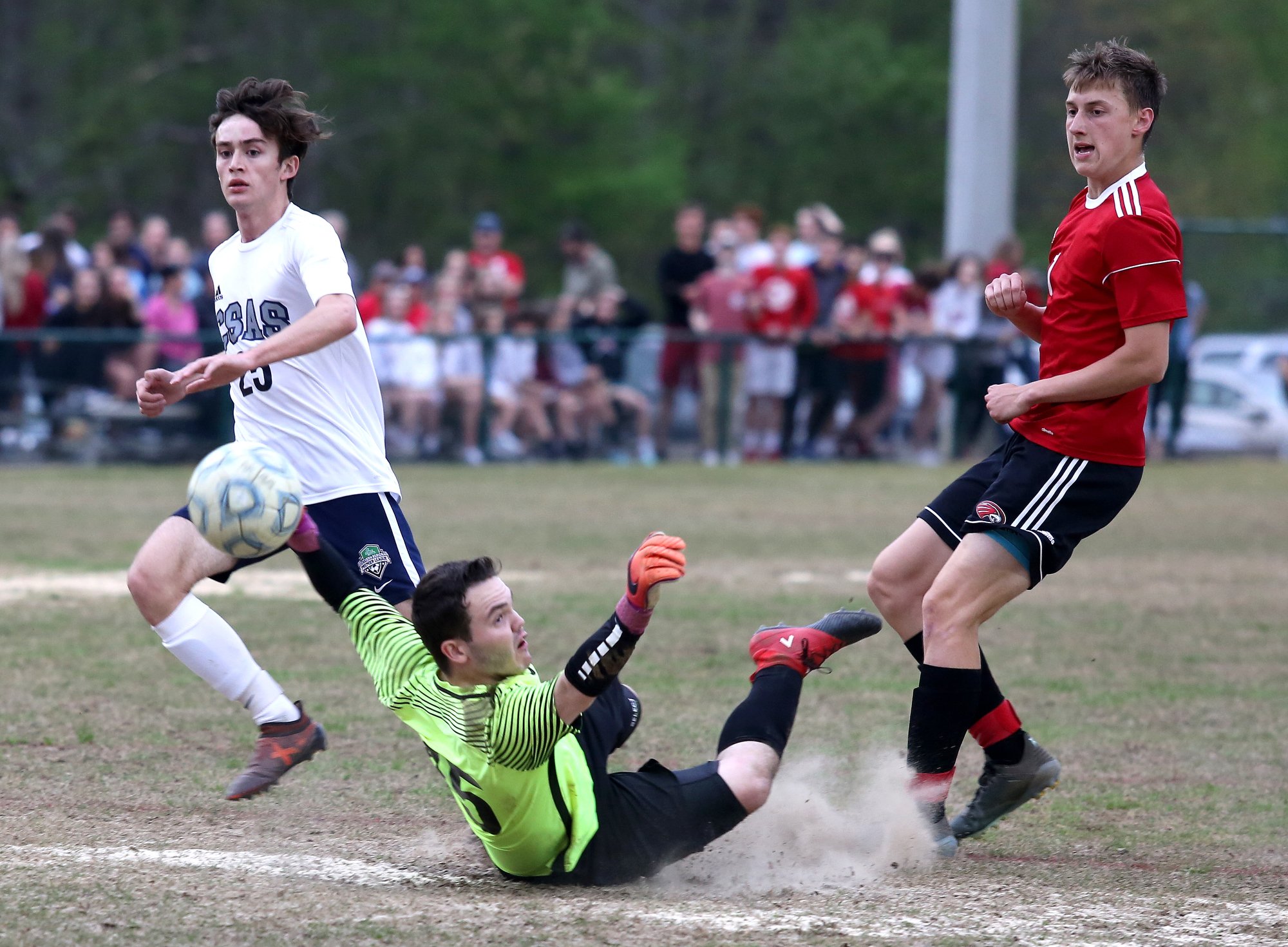 Chattanooga School for the Arts and Sciences' Nicholas Webber (25) watches the ball as CSAS goalie Fisher Latham (45) attempts to stop a goal from Signal Mountains' George Coogan (1) during the Signal Mountain vs. CSAS boys soccer game at Signal Mountain High School Thursday, April 18, 2019 in Signal Mountain, Tennessee.