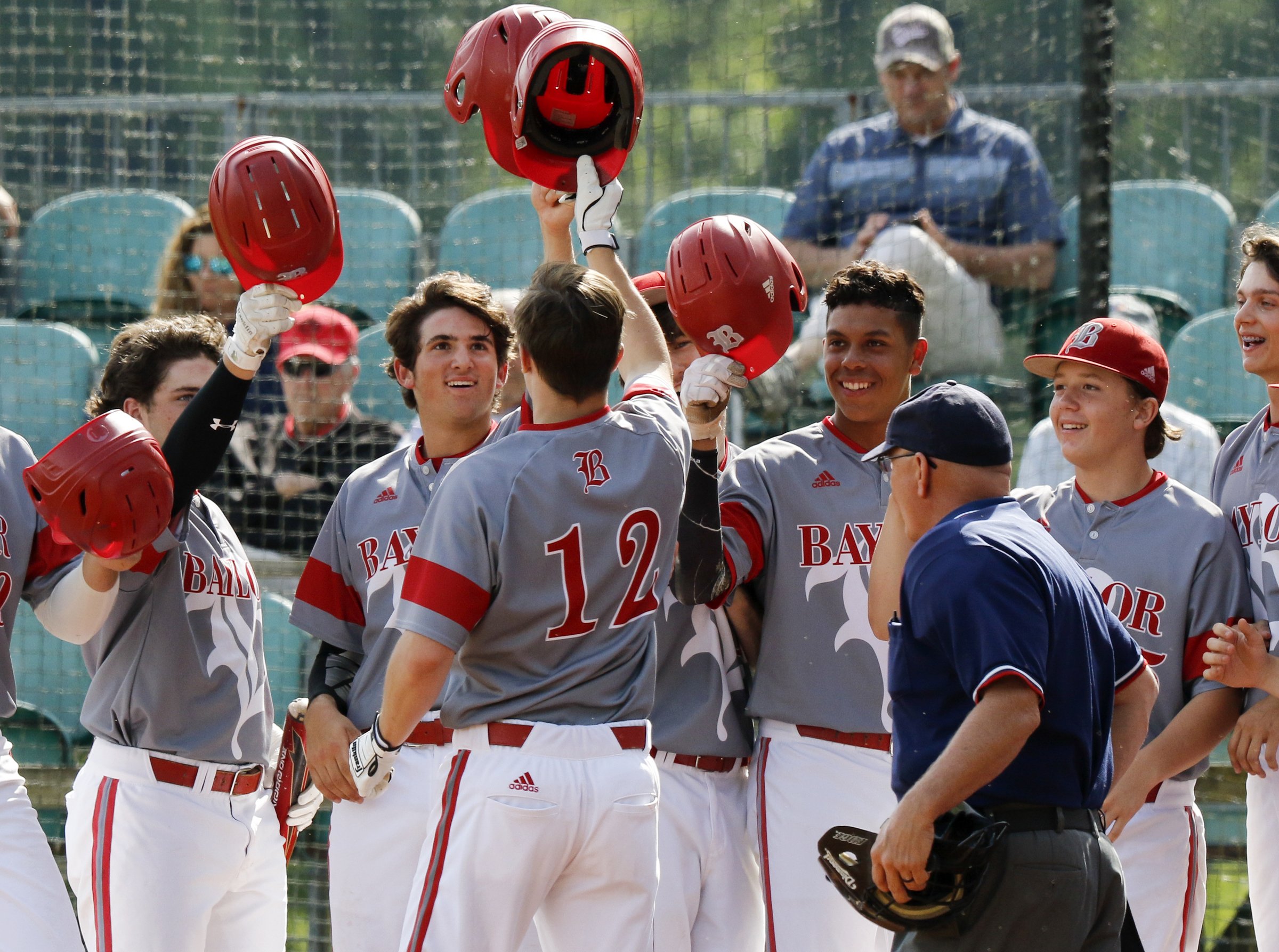 Baylor's Colin Ahearn (12) celebrates at home plate with his teammates after hitting a grand slam in the bottom of the first inning against Memphis University School during Game 1 of a double header in the Division II-AA quarterfinals at Wyatt McMahan Field on the campus of Baylor Schoolon Wednesday, May 15, 2019 in Chattanooga, Tenn.