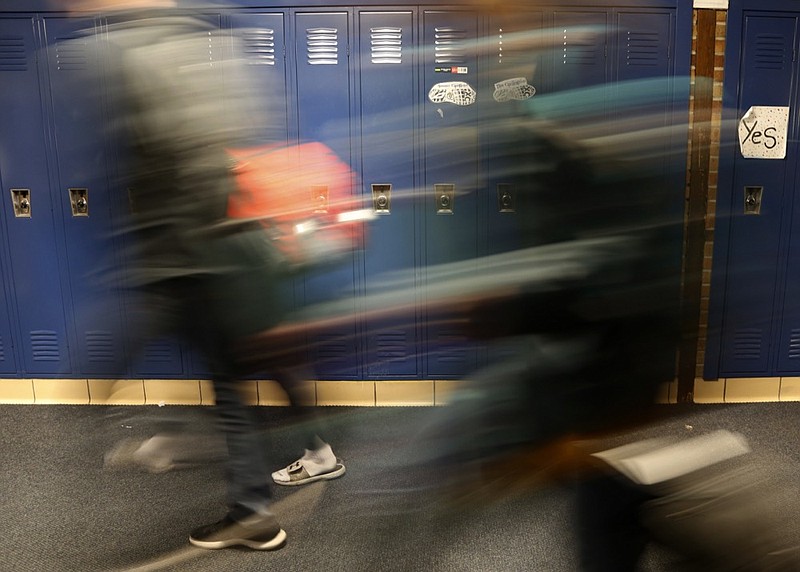 Students walk through a hallway at Cadillac High School in Cadillac, Mich., on Wednesday, April 17, 2019. The topic of consent for sexual activity - including the age when a student can legally say "yes" to sexual activity - has been a frequent matter of discussion in freshman health classes here in the #MeToo era. The legal age of consent in the state Michigan is 16. (AP Photo/Martha Irvine)

