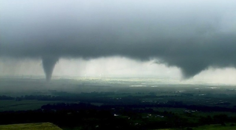 This image made from video provided by KWTV-KOTV shows two funnel clouds formed in Crescent, Okla., Monday, May 20, 2019. An intense storm system that weather forecasters labeled "particularly dangerous" swept through the Southern Plains Monday, spawning a few tornadoes that caused some damage and a deluge of rain but no reports of injuries. (KWTV-KOTV via AP)

