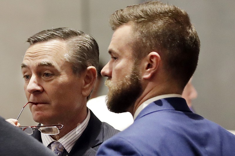 FILE - In this May 2, House Speaker Glen Casada, R-Franklin, left, talks with Cade Cothren, right, his then-chief of staff, during a House session in Nashville. Casada had announced he will resign the speakership after a raft of scandals. (AP Photo/Mark Humphrey, File)