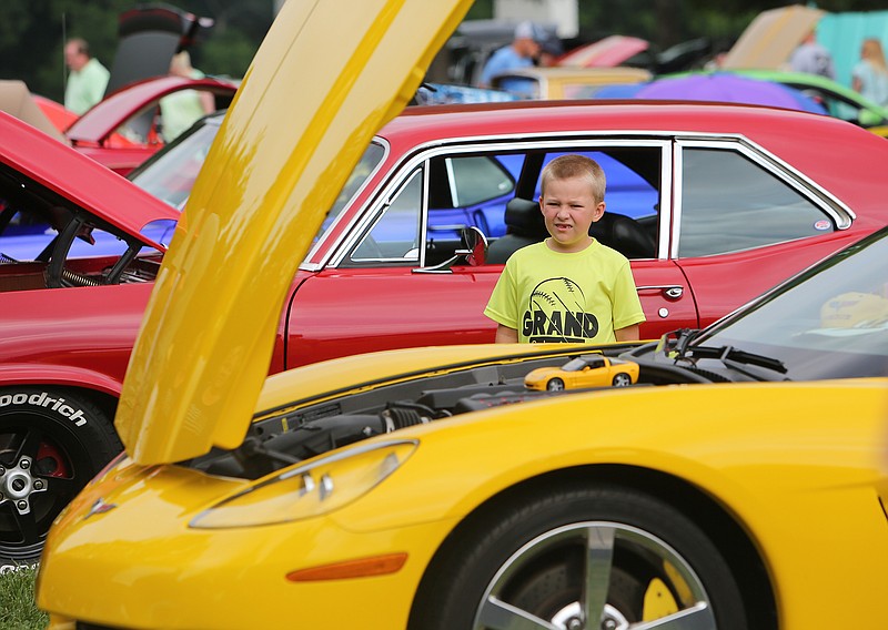 Brayden Nelson checks out a 2008 Corvette during the 2018 Harrison Ruritan Club Car Show.