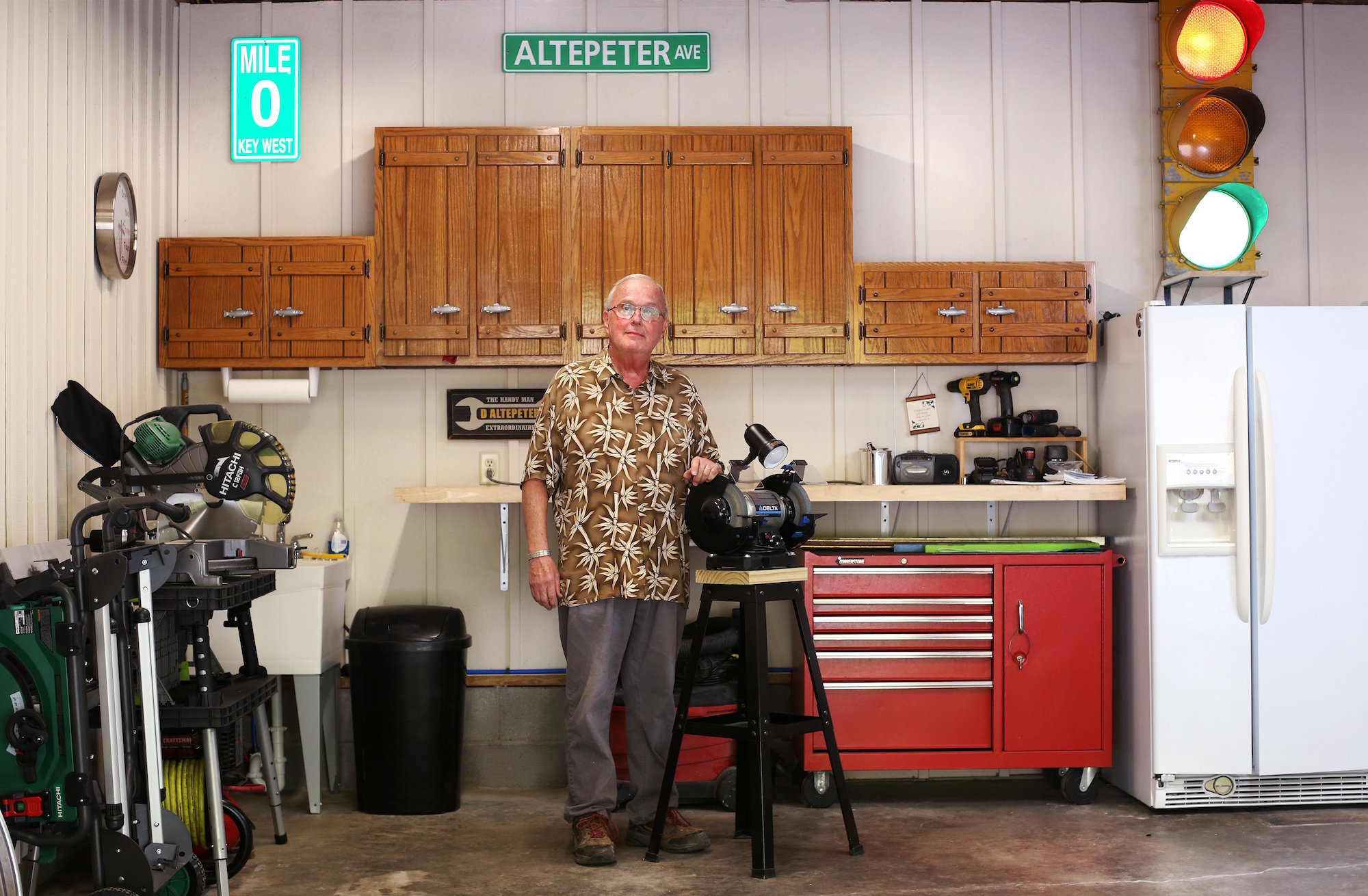 Dave Altepeter poses for a photo in his garage Tuesday, April 17, 2019 in Soddy-Daisy, Tennessee. Altepeter adapted his two-car garage into a workshop. He has big storage lockers for tools, fold-up workshop equipment, workbench, side-by-side refrigerator with ice maker, laundry sink, bright ceiling lights and board-and-batten painted walls.