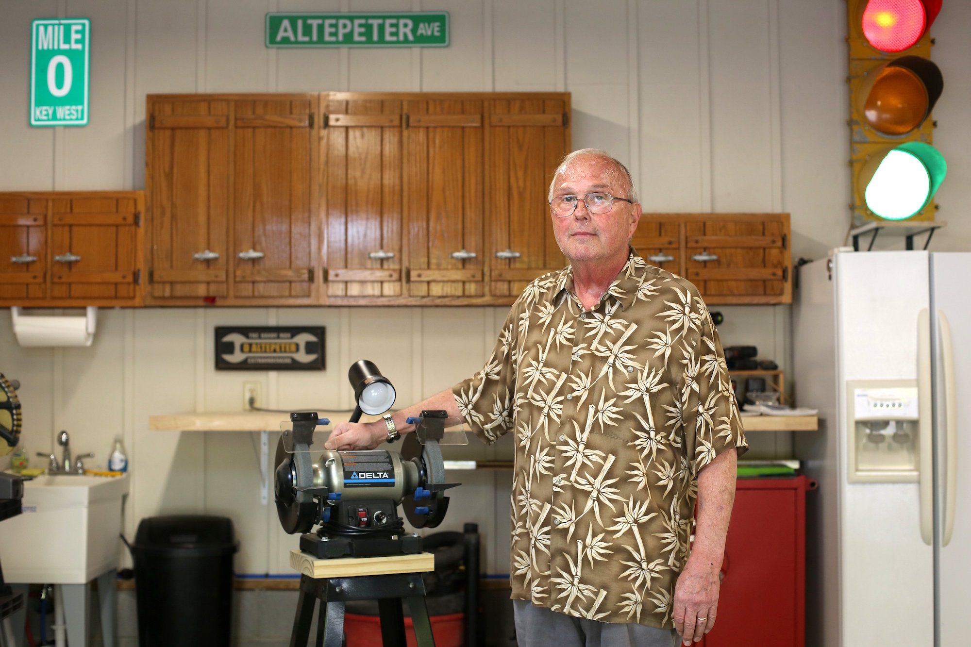 Dave Altepeter poses for a photo in his garage Tuesday, April 17, 2019 in Soddy-Daisy, Tennessee. Altepeter adapted his two-car garage into a workshop. He has big storage lockers for tools, fold-up workshop equipment, workbench, side-by-side refrigerator with ice maker, laundry sink, bright ceiling lights and board-and-batten painted walls.