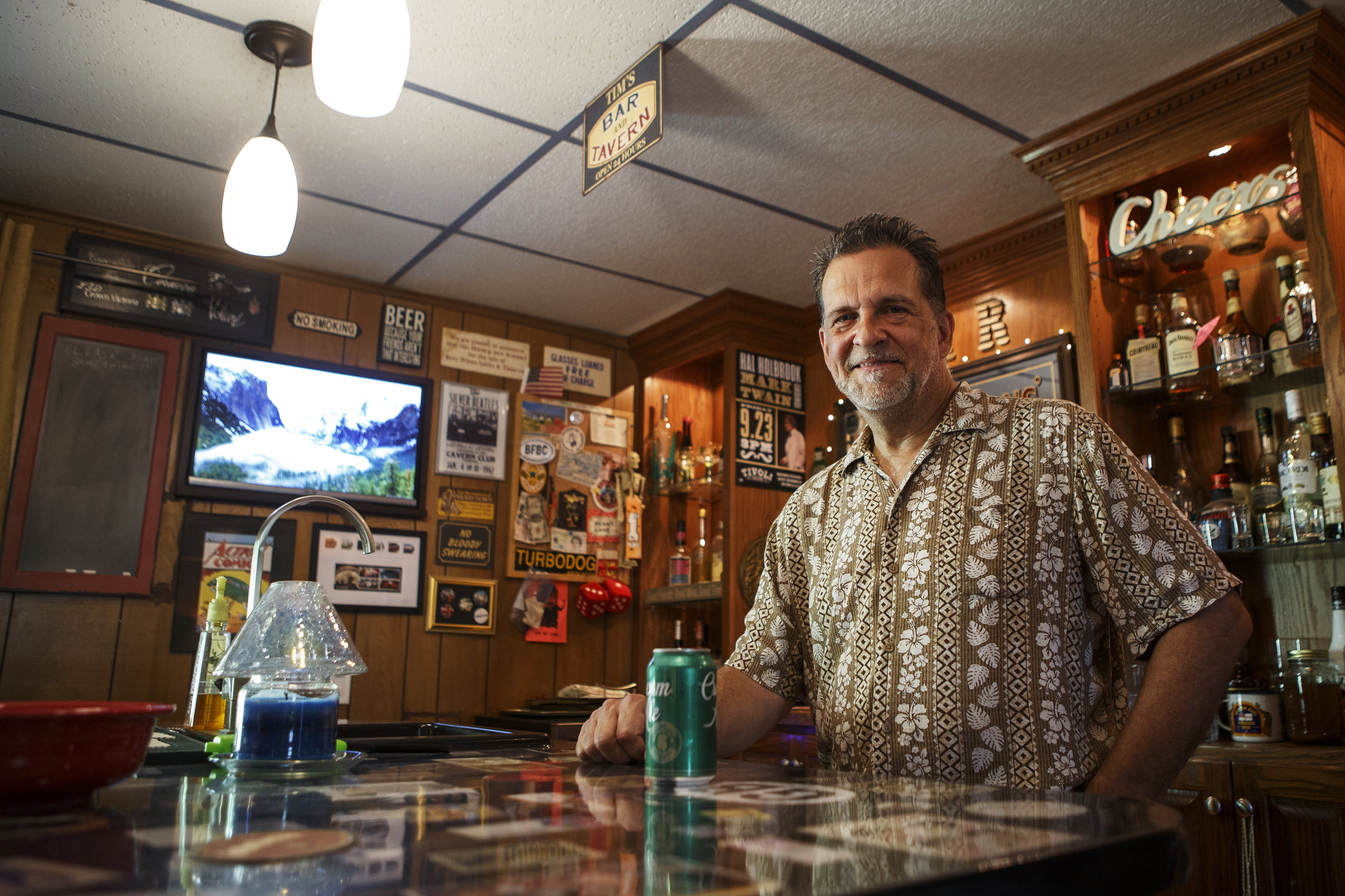 Timothy King poses in his man cave at his home on Monday, May 6, 2019 in Hixson, Tenn. King's man cave includes three televisions, 14 speakers inside (with an additional four outside in the backyard of the split level home), a pool table and a bar.