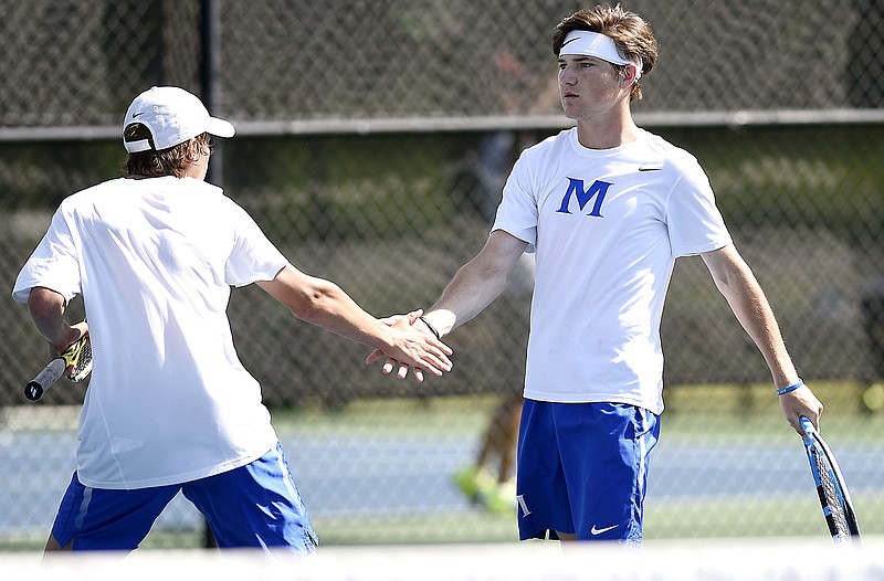 McCallie's Charlie Griffin, left, and teammate John Knight celebrate a point in their match with Baylor's Felipe Freitas and Matthew Huinker, not pictured, during the TSSAA Division II-AA boys' tennis team state tournament Tuesday at the Adams Tennis Complex in Murfreesboro.