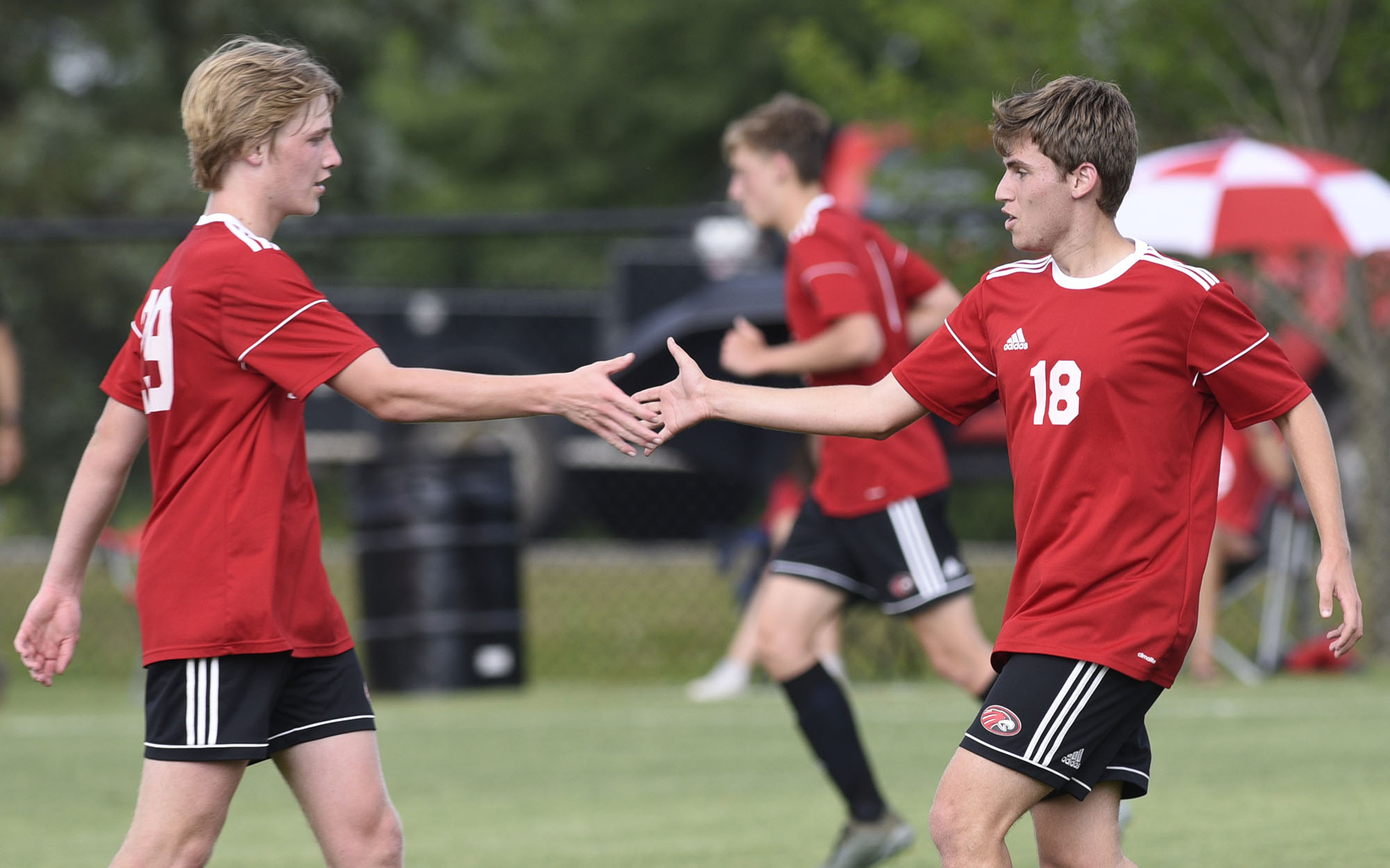 Signal Mountain's Nicholas Galea (18) shakes hands with Tristan Santelmann (29) after Galea scored the Eagles second goal. The TSSAA Division II Soccer Tournament was held at Siegel Park in Murfreesboro on May 21, 2019.