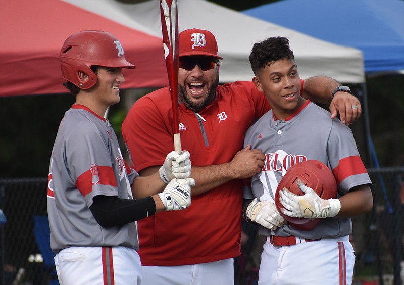 Baylor School co-head baseball coach Greg Elie, center, cuts up with Danny Corona, right, and Cooper Kinney during a 10-0 victory over Ensworth in the Division II-AA state tournament during the 2019 season. Corona smacked two of the Red Raiders' six extra-base hits in the game at Wilson Central High School. / Staff photo by Patrick MacCoon