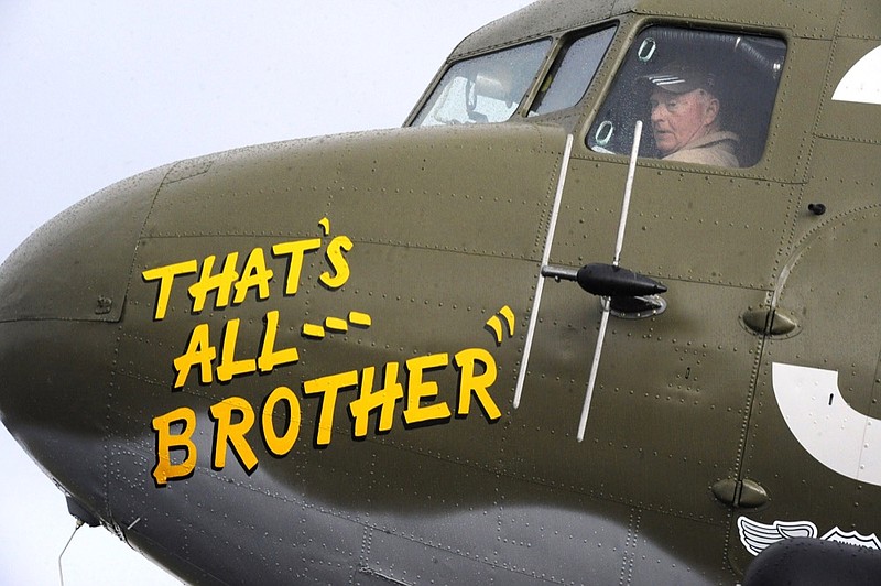 In this April 9, 2019, photo, Pilot Tom Travis sits in the cockpit of the World War II troop carrier That's All, Brother during a stop in Birmingham, Ala. The C-47 aircraft, which led the main Allied invasion of Europe on June 6, 1944, is returning to the continent to participate in events marking the 75th anniversary of D-Day in June. (AP Photo/Jay Reeves)

