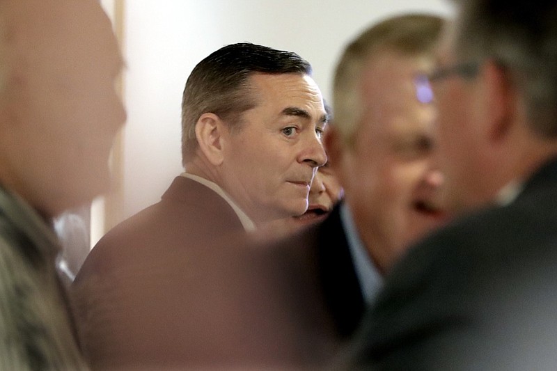 House Speaker Glen Casada, R-Franklin, center, talks with people before a meeting of the House Republican Caucus at a hotel Monday, May 20, 2019, in Nashville, Tenn. The caucus is meeting to discuss the future of Casada, who is ensnarled in a texting scandal. (AP Photo/Mark Humphrey)