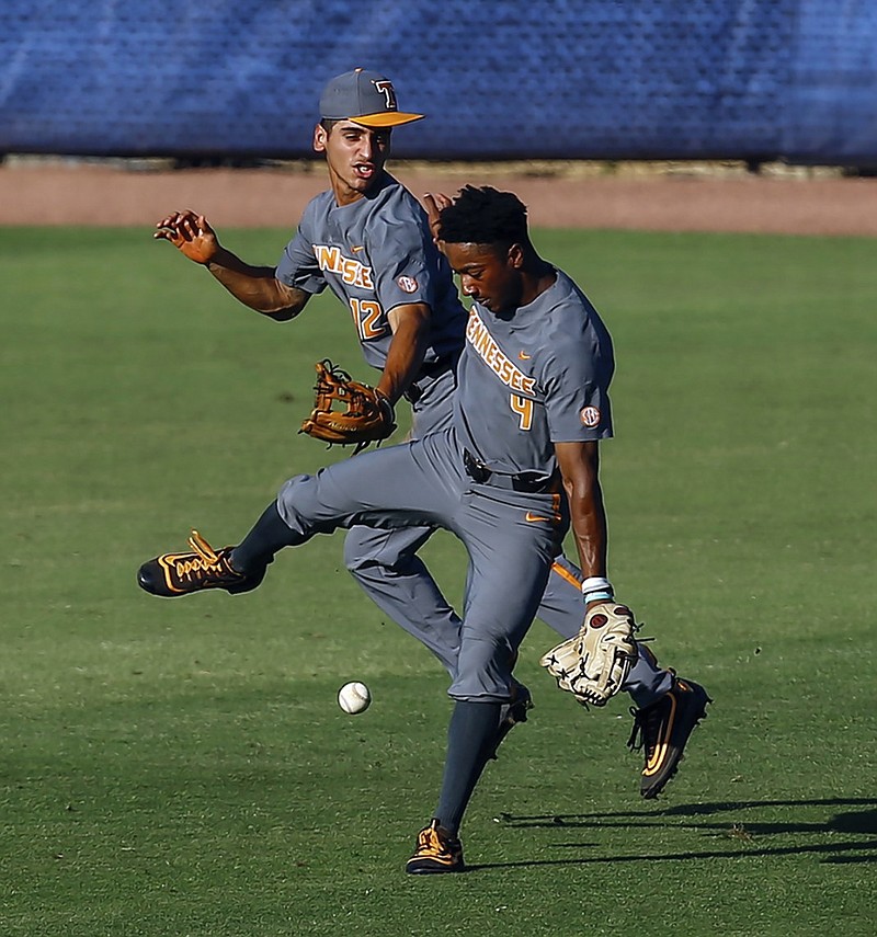 Tennessee center fielder Jay Charleston, right, and shortstop Ricky Martinez collide trying to field a fly ball hit by Auburn's Edouard Julien during the second inning of their SEC tournament first-round game Tuesday in Hoover, Ala. Auburn, seeded ninth for the tournament, beat the eighth-seeded Vols 5-3.