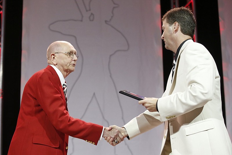 Chattanooga Times Free Press sports editor Stephen Hargis, right, presents high school basketball coach Jerry Jones with the Unselfish Sportsman Award at the 2014 Best of Preps Banquet on May 29, 2014, at the Chattanooga Convention Center.