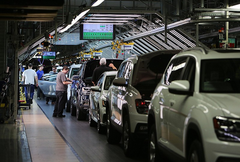 Volkswagen employees work around vehicles moving down the assembly line at the Volkswagen Assembly Plant Thursday, Aug. 31, 2017, in Chattanooga, Tenn. 