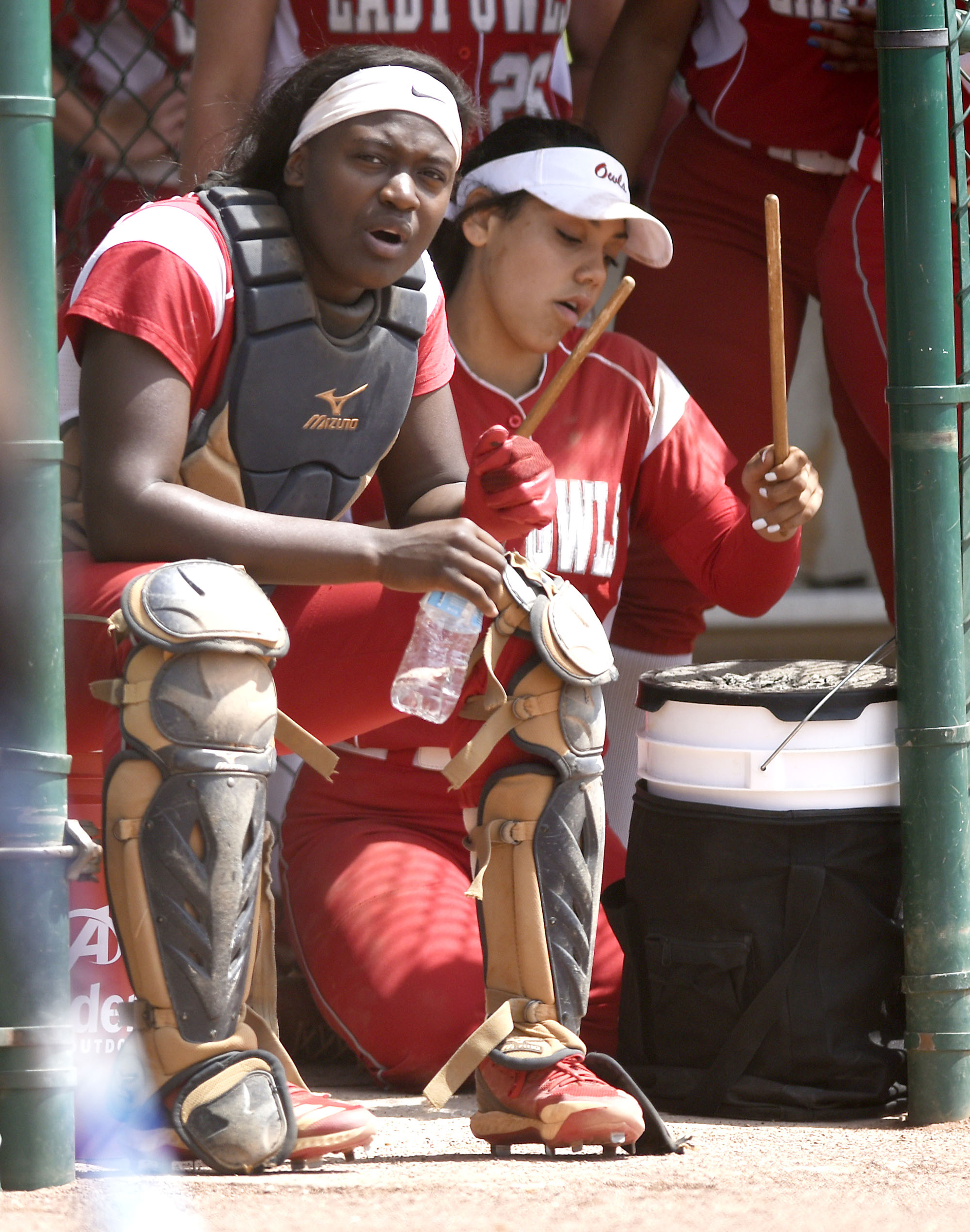 Ooltewah catcher Cheyanne Sales (9) encourages her teammates while another Lady Owl uses a water cooler as a drum. McCallie faced Montgomery Bell Academy in the team state championship of the TSSAA Division II Class AA at the Adams Tennis Complex in Murfreesboro on May 22, 2019.