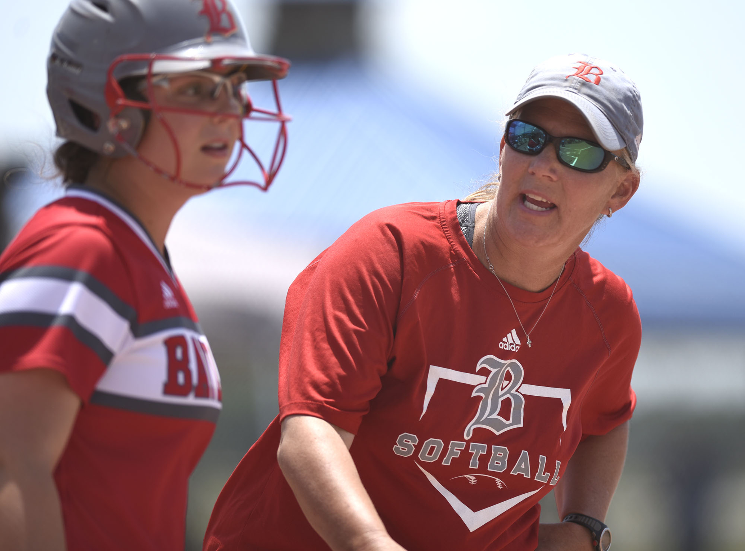 Baylor head coach Kelli Smith talks with the umpire as Sophie Piskos (23) stands in the batter's box. GPS faced Baylor in the semifinals of the TSSAA Division II Class AA State Girls's softball tournament at McKnight Fields on May 22, 2019.