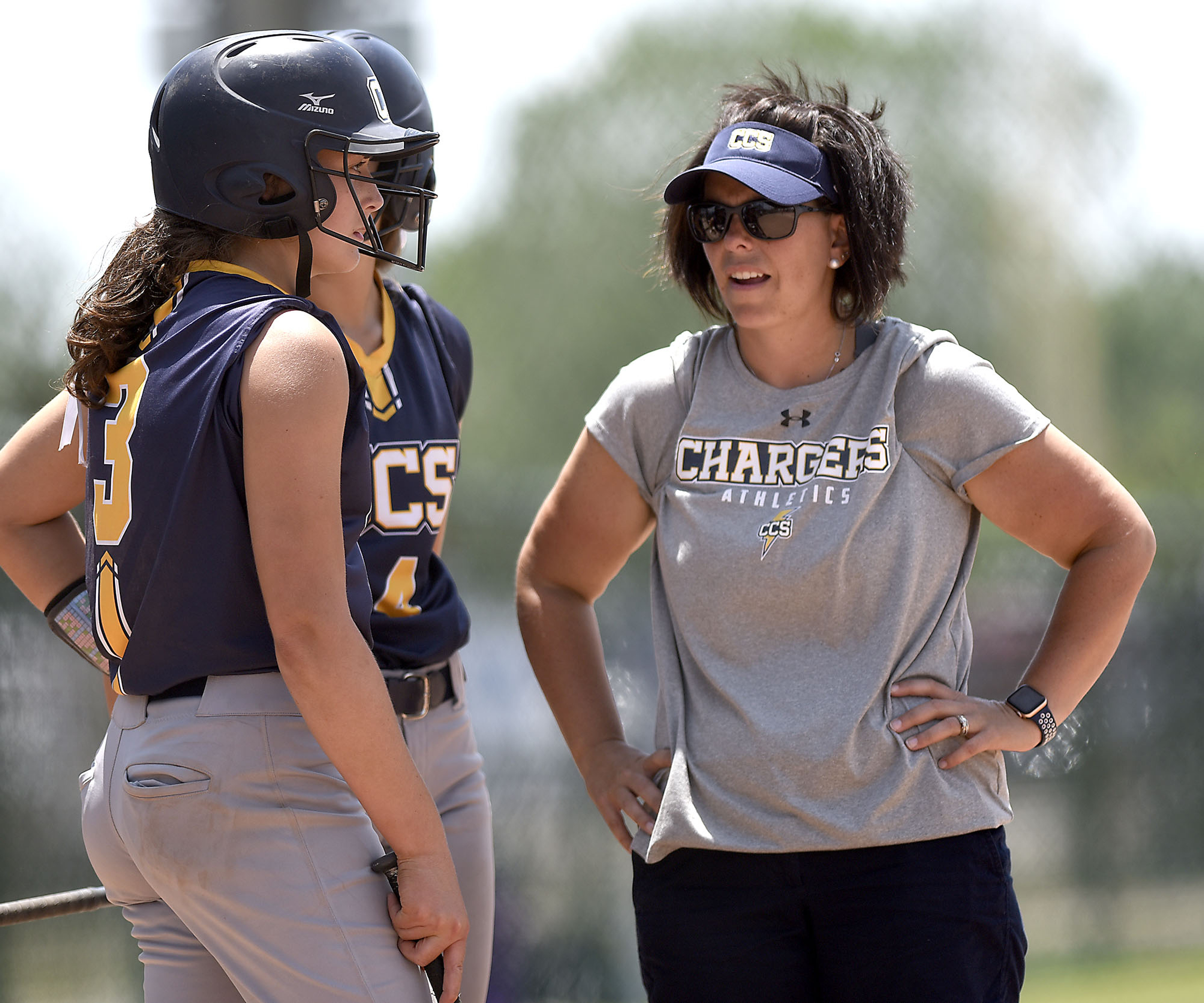 CCS head coach Lisa Gray confers with Mary Vandergriff (3) and Madison Vandergriff (4). Chattanooga Christian faced Davidson Academy in the quarterfinals of the TSSAA Division II Class A state girls's softball tournament held at the Starplex in Murfreesboro on May 22, 2019.