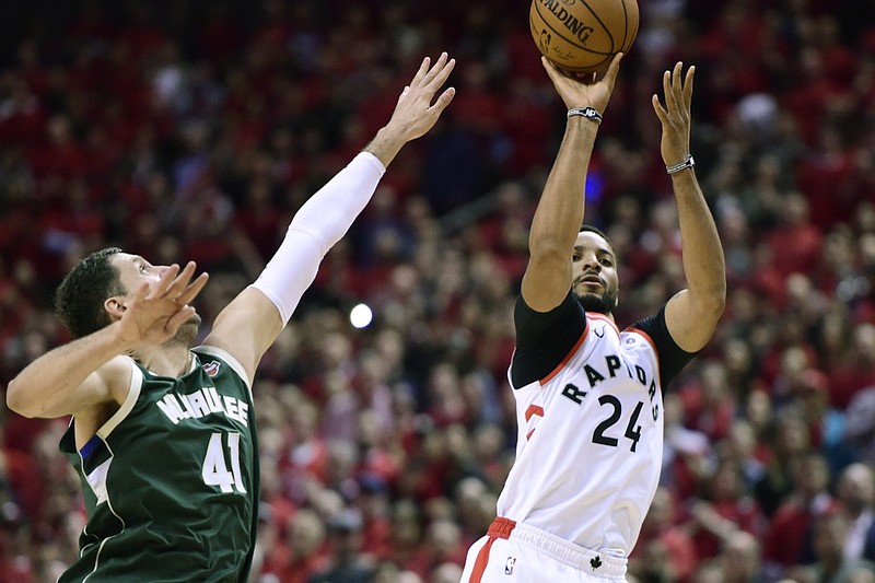 Milwaukee Bucks forward Nikola Mirotic (41) reaches for the ball but can't stop Toronto Raptors forward Norman Powell's three point basket during the second half of Game 4 of the NBA basketball playoffs Eastern Conference finals, Tuesday, May 21, 2019 in Toronto. (Frank Gunn/The Canadian Press via AP)
