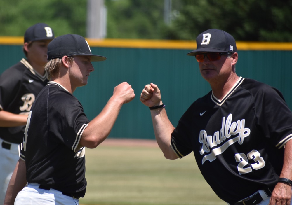 Staff photo by Patrick MacCoon /
Bradley Central starting pitcher Dylan Standifer fist-bumps with coach Travis Adams in Wednesday's 6-3 win over Independence in Murfreesboro.