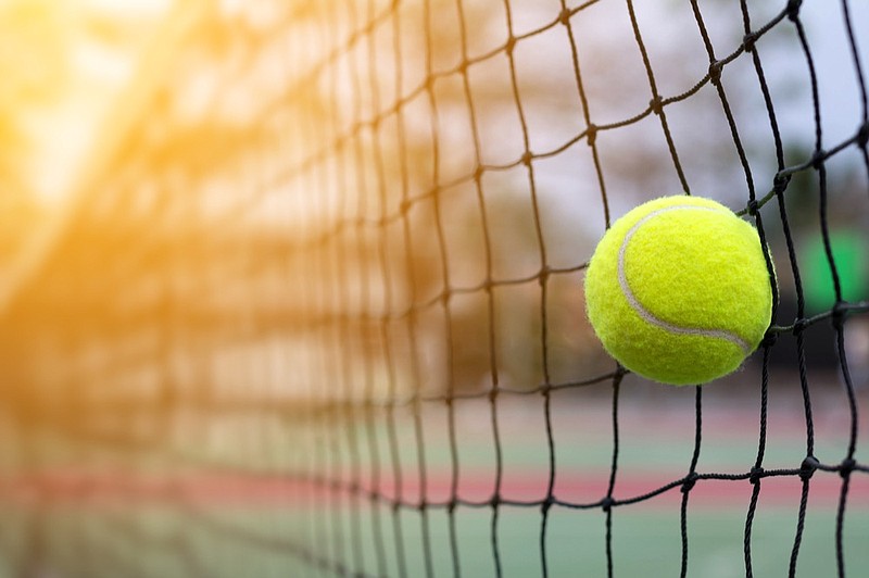 Tennis ball hitting to net on blur court background tennis tile / Getty Images
