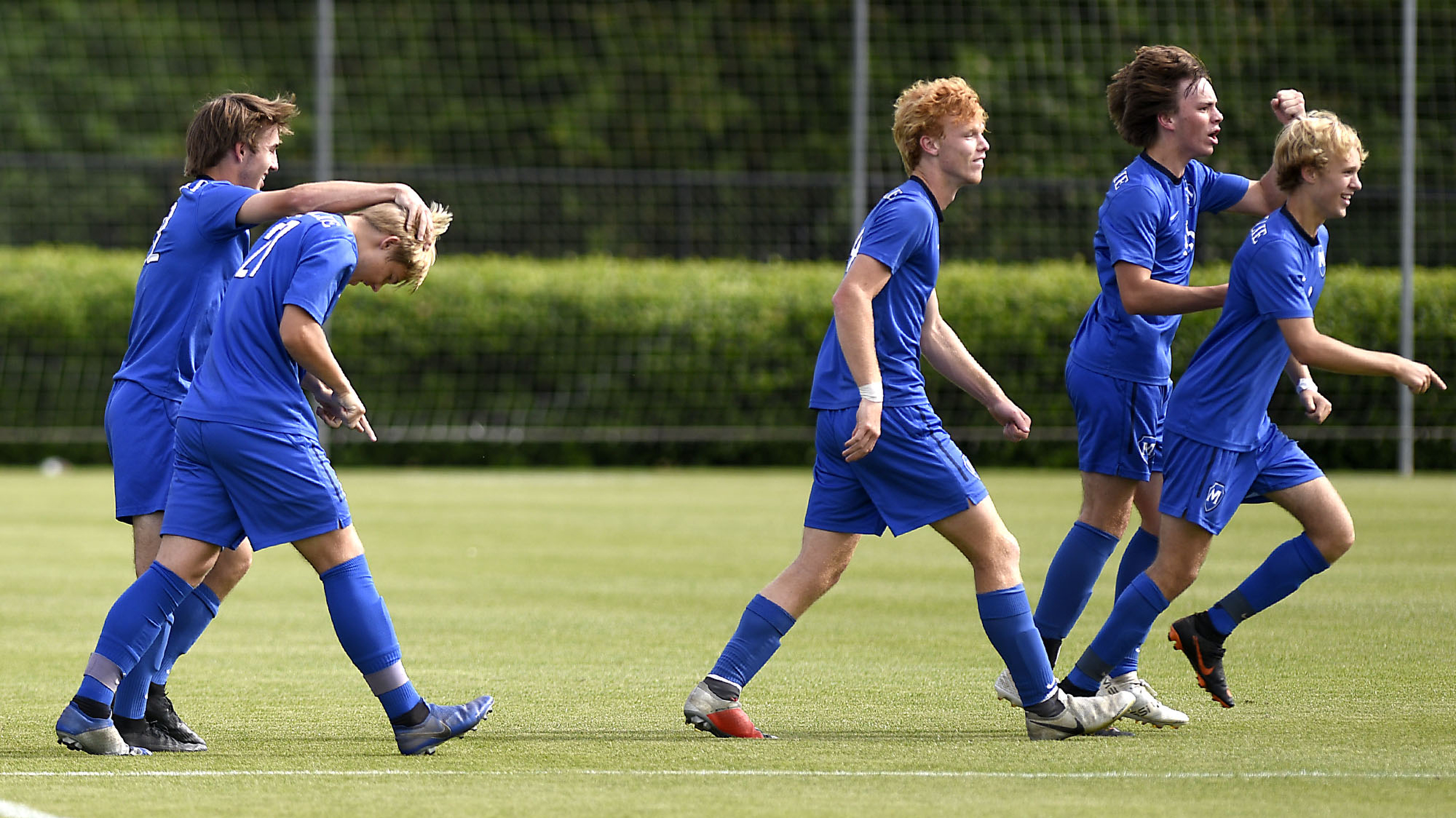 McCallie's Ryan Rogers (22) rubs the head of Neal Carson (27) after Carson scored the Blue Tornado's first goal. McCallie faced Montgomery Bell Academy for the TSSAA Division II Class AA state soccer championship at the Richard Siegel complex on May 23, 2019.