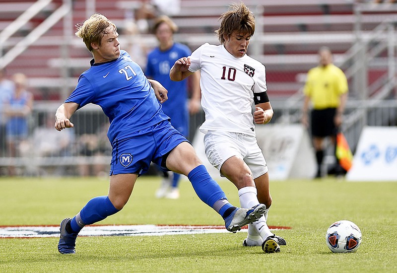 McCallie's Neal Carson (27) keeps the ball a head of MBA's Henry Hylbert (10).  McCallie faced Montgomery Bell Academy for the TSSAA Division II Class AA state soccer championship at the Richard Siegel complex  on May 23, 2019.  