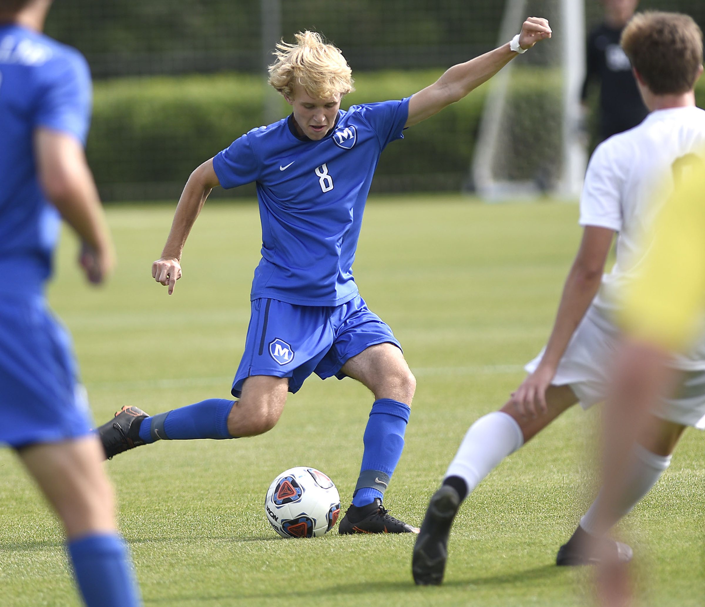 McCallie's Clark Maize (8) kicks the ball into the Big Red zone. McCallie faced Montgomery Bell Academy for the TSSAA Division II Class AA state soccer championship at the Richard Siegel complex on May 23, 2019.