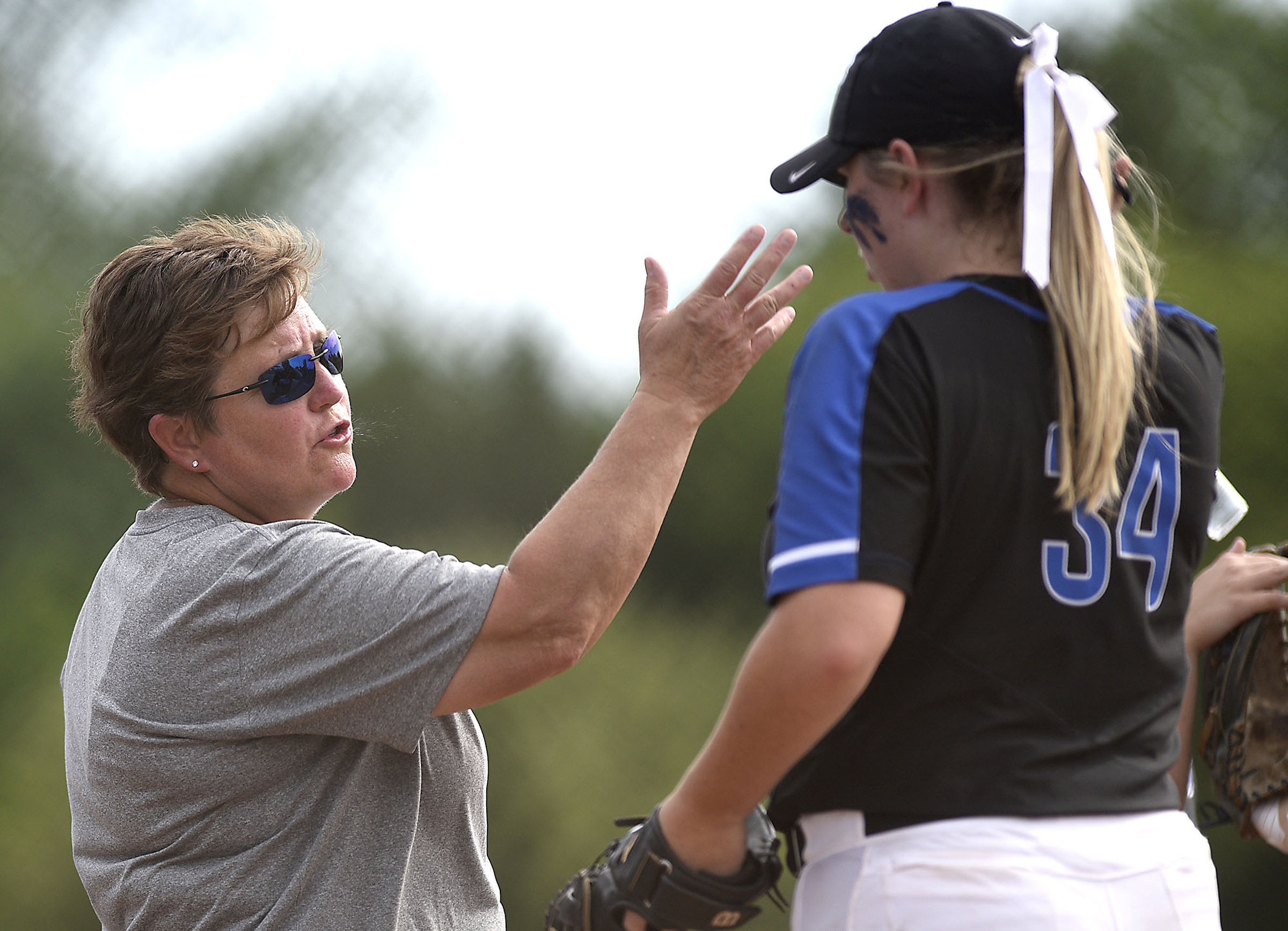 GPS head coach Susan Crownover confers with Hannah Sanders (34). Baylor defeated GPS 2-1 for the TSSAA Division II Class AA softball championship at the Starplex in Murfreesboro on May 23, 2019.