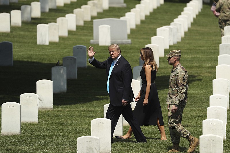 President Donald Trump and first lady Melania Trump on Thursday visit Arlington National Cemetery for the annual 'Flags In' ceremony ahead of Memorial Day. (AP Photo/Andrew Harnik)
