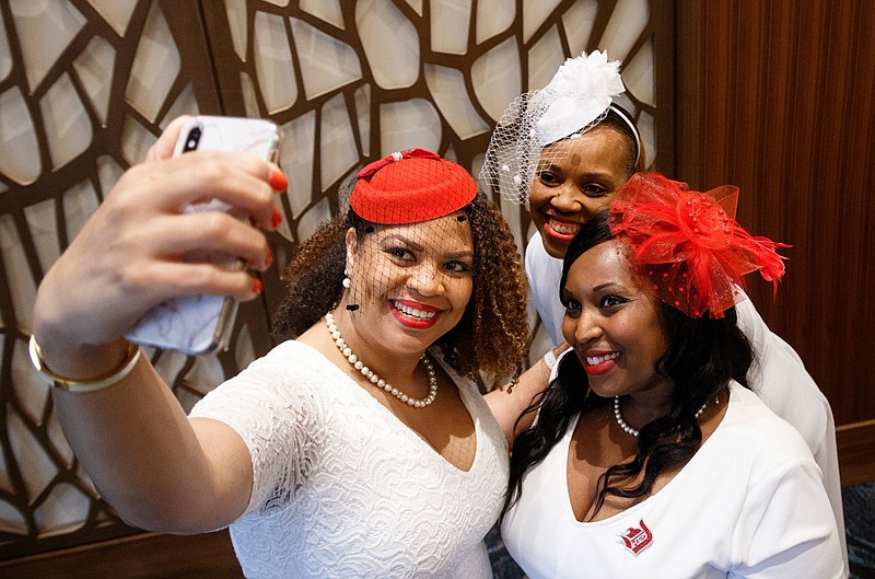 Val Armstrong, Donna L. Harrison and Shaquana Kennedy, clockwise from left, take a selfie during the Dr. Dorothy Height Inaugural Tea held at The Westin.