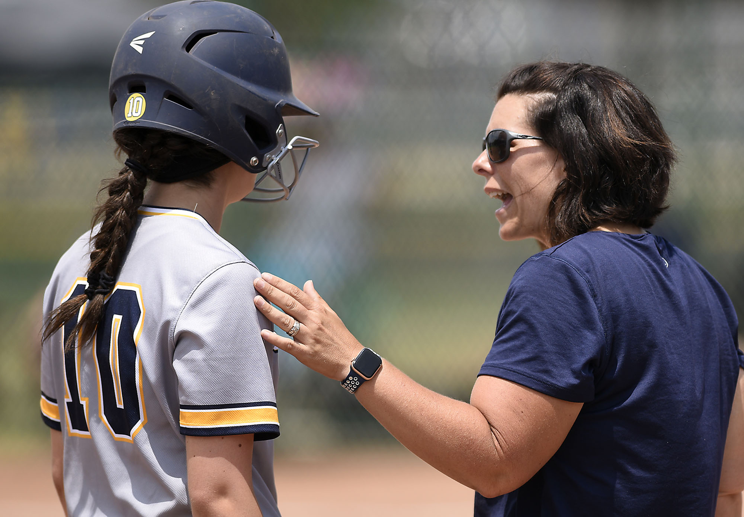 CCS head coach Lisa Gray instructs Miranda Blevins (10) as she stands on third base. Chattanooga Christian School lost to King's Academy 3-1 in the finals of the TSSAA Division II Class A softball championship held at the Starplex in Murfreesboro on May 24, 2019.