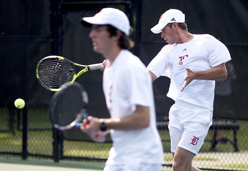 Baylor's Hunter Smith hits a forehand while doubles teammate Benji Taverne stands ready at the net in the state championship match they won Friday against McCallie's John Knight and Charlie Park at the Adams Tennis Complex in Murfreesboro.