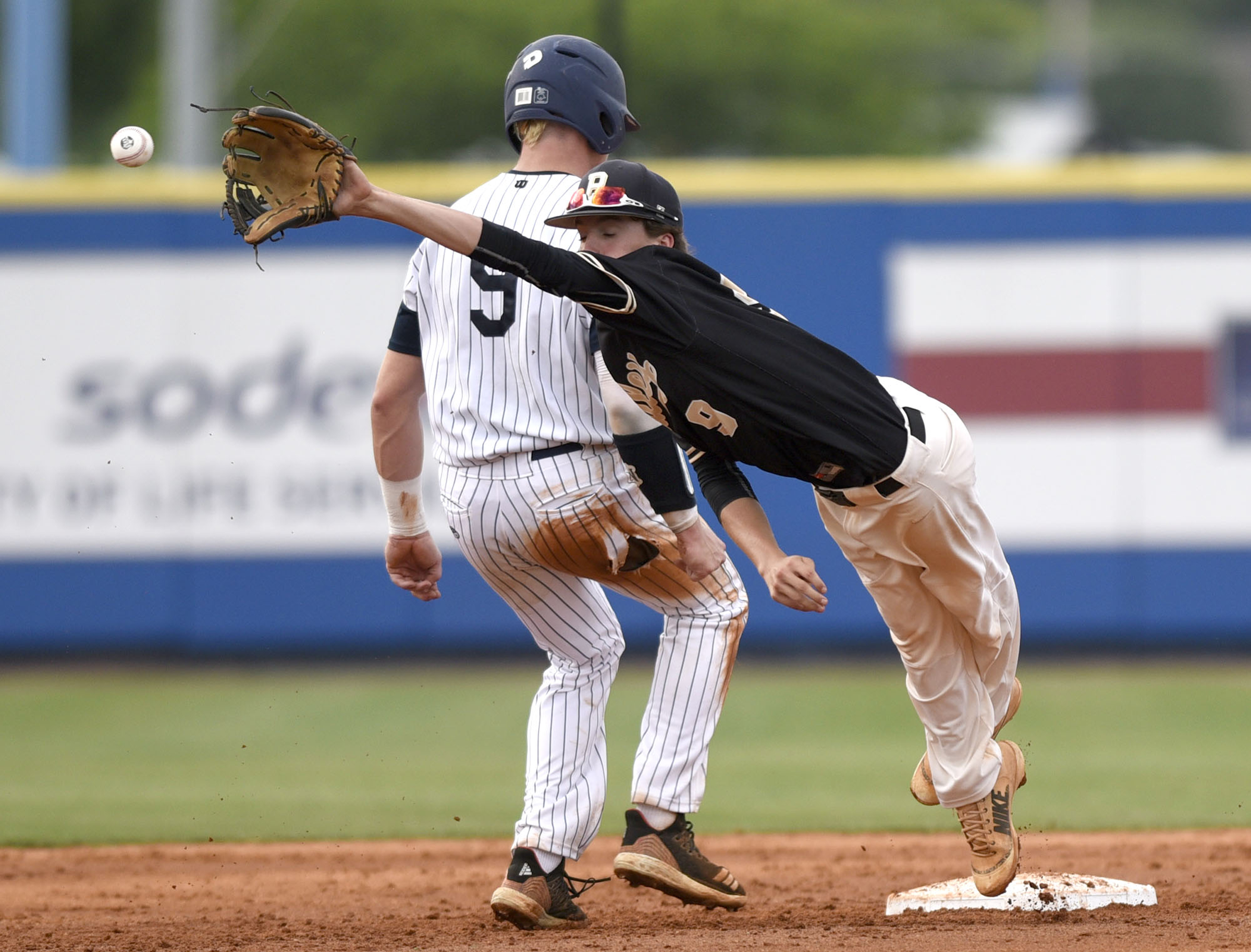 Bradley Central shortstop Ashton Simmons stretches out to try to catch a pickoff attempt in Friday's Class AAA state championship game at Middle Tennessee State University. Center fielder Caden Sherlin backed up the play, and the runner did not advance.