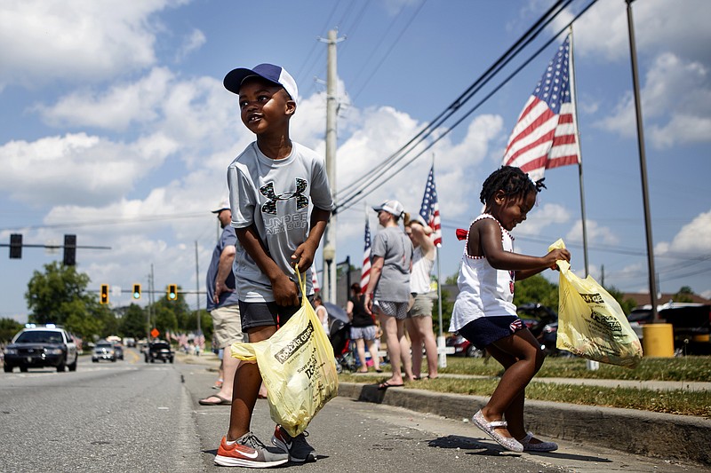 Six-year-old Jacob, left, and 3-year-old Ava Foster collect candy from the parade during the 1890s Day Jamboree on Saturday, May 25, 2019 in Ringgold, Ga. The two-day street festival concluded Saturday. The event includes vendor booths, a parade, a car show, kid activities, live music and various competitions.