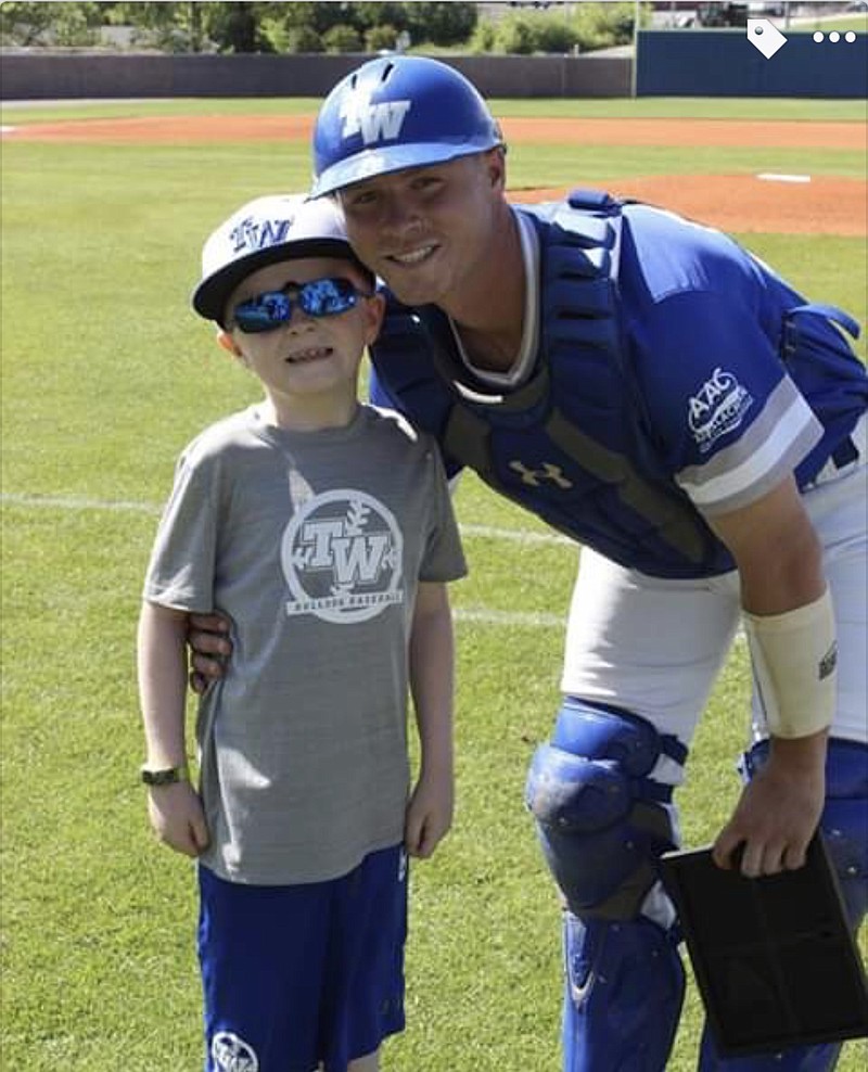 Tennessee Wesleyan catcher Alex Balter, right, had inspirational 8-year-old Neyland Pickel accompany him on the field for his senior day recognition.