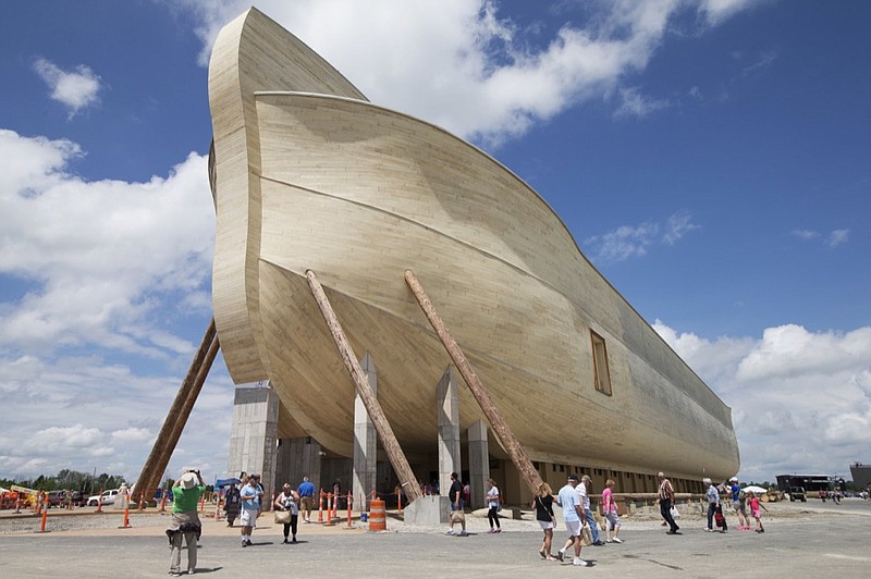FILE - In this July 5, 2016, file photo, visitors pass outside the front of a replica Noah's Ark at the Ark Encounter theme park during a media preview day, in Williamstown, Ky. In the Bible, the ark survived an epic flood. Yet the owners of Kentucky s Noah s ark attraction are demanding their insurance company rescue them from flooding that caused nearly $1 million in property damage. (AP Photo/John Minchillo, File)

