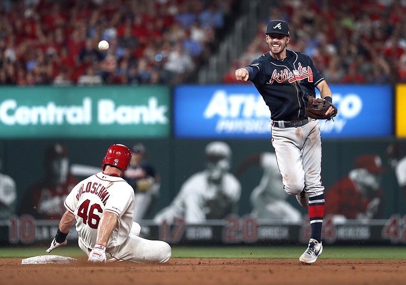 The St. Louis Cardinals' Paul Goldschmidt, left, is out at second base but Atlanta Braves shortstop Dansby Swanson is unable to turn a double play during the eighth inning of Saturday night's game in St. Louis. Paul DeJong was safe at first.