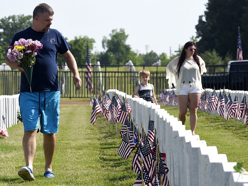 From left, Bo Christison, Brooke Potent and Elijah Satterfield, all of Cleveland, look  for the grave of their family member before the ceremony.  The Chattanooga Area Veterans Council hosted the Memorial Day ceremony at the Chattanooga National Cemetery on May 27, 2019.  