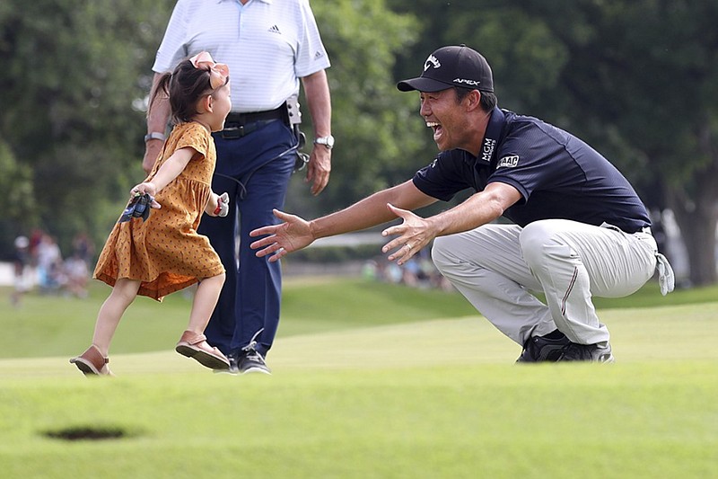 Sophia Na runs to her father Kevin Na after he won the PGA Tour's Charles Schwab Challenge on Sunday at Colonial Country Club in Fort Worth, Texas.