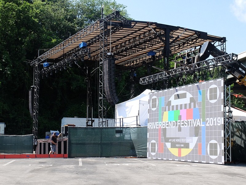 At the foot of the Bud Light Stage, Jack Bowers, lower left, of Nashville, runs cable for cameras and one of the six LED walls, background, provided by AP Live, Tom Atema, owner. "We have four front-house cameras and two hand held cameras on the (deck) Coca-Cola Stage," Atema said.
