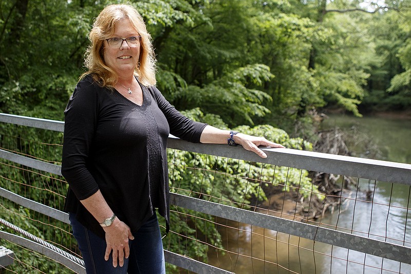 Chattanooga Audubon Society Executive Director Darlene Carlson poses on the swing bridge at Audubon Acres on Friday, May 3, 2019 in Chattanooga, Tenn.