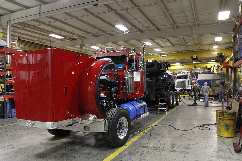 Staff file photo / Employees put tow-trucks together in the large wrecker assembly shop at the Ooltewah manufacturing facility of Miller Industries in this file photo.