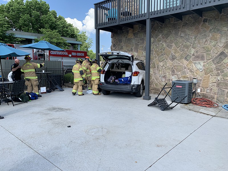 Firefighters work the scene at The Grove at Hickory Valley apartment complex, where a vehicle crashed through the fence surrounding the swimming pool and clubhouse, crashing into the clubhouse building and coming to rest halfway inside the laundry room for the apartment complex. No one was injured in the crash. / Photo by Capt. Chuck Hartung / Chattanooga Fire Department